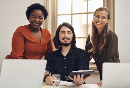 Business growth is based on successful teamwork. Portrait of a group of businesspeople working together in an office.の写真素材