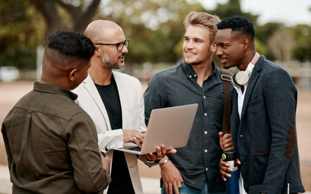 Improving the customer experience one campaign at a time. a group of businessmen using a laptop against a city background.の写真素材