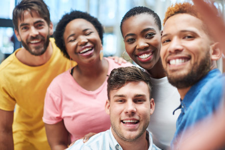 Its not a website without a meet the team page. a group of young businesspeople taking a selfie...