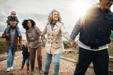 Family, travel and adventure outdoor holding hands with children, parents and grandparents with...