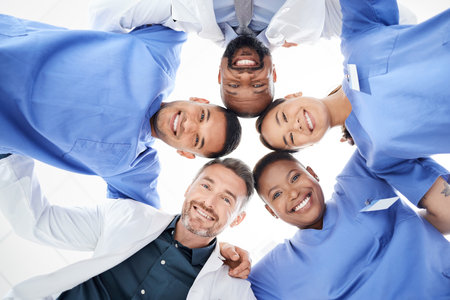 The doctor is in. Portrait of a group of medical practitioners joining their heads together in a huddle.の写真素材