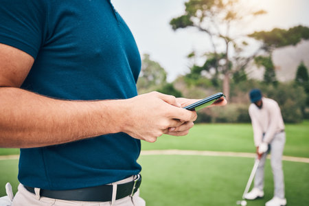 Man, hands and phone texting in communication on golf course for sports, social media or networking outdoors. Hand of sporty male chatting on smartphone or mobile app for golfing research or browsingの写真素材