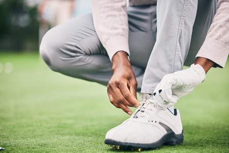 Closeup, golf and man tie shoelace, fitness and success with game, playing and workout outdoor. Male athlete, guy and player, tying laces and training for match, competition and sports for wellnessの写真素材