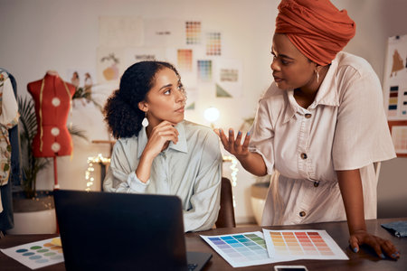 Laptop, meeting or fashion designer women in office planning, collaboration or thinking of creative color wheel. Small business, diversity or startup working for teamwork, analysis or strategyの写真素材