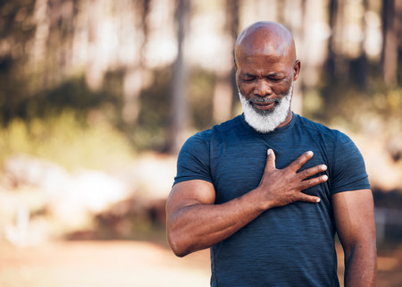 Black man, heart attack and health for outdoor exercise, park and running workout. Senior sports male, chest and stroke for fitness emergency, asthma and muscle pain from cardiac injury, risk or bodyの写真素材