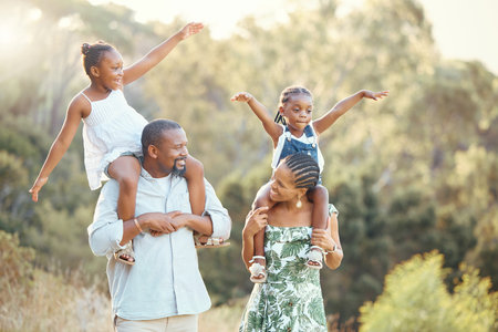 Family nature walking park, children and parents happy on walk in garden, communication with smile in summer and comic kids support from mother and father. African man and woman together with girlsの写真素材