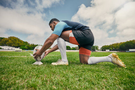Rugby kick, sports man or ball in training game, practice workout or match on stadium field outdoors. Fitness, ready or athlete player in action playing in cardio exercise on grass in France, Parisの写真素材