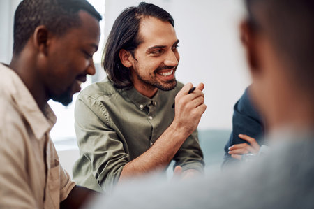 Listening is a part of success. a diverse group of businesspeople sitting together and having a...