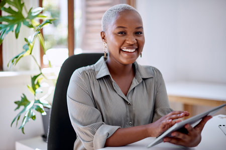 Innovation is what adds value to what I do. Portrait of a young businesswoman using a digital tablet in an office.の写真素材