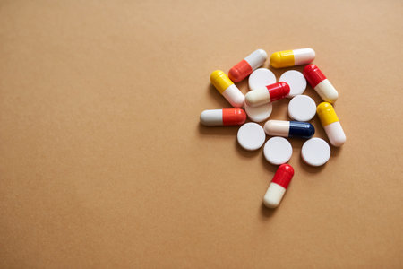 Say goodbye to what ails you. Studio shot of a pile of different tablets against a brown background.の写真素材