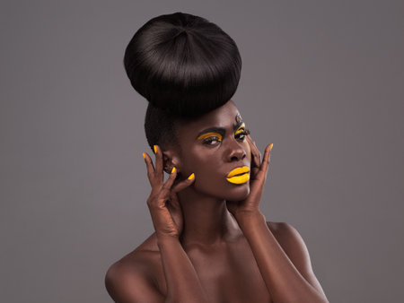 The more unique, the more beautiful. Studio portrait of a beautiful young woman posing against a grey background.の写真素材