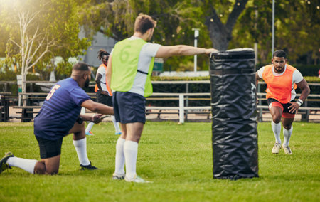 Rugby, teamwork and men training on field with equipment ready for match, practice and sports game. Fitness, performance and male athletes running for warm up, exercise and workout for competitionの写真素材