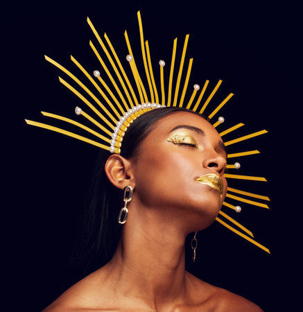 Crown, gold makeup and a beauty queen isolated on a black background in a studio. Dreaming. ethereal...