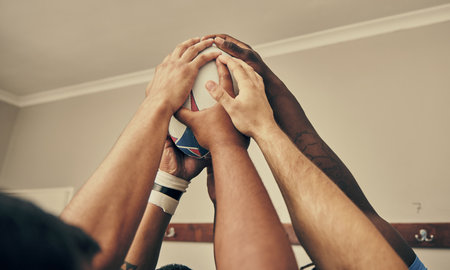 Locker room, hands together and rugby team huddle with with ball, motivation and teamwork before game. Training, coaching and group of motivated sports players with commitment, dedication and supportの写真素材