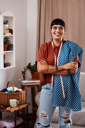 Its polka dot season in the fashion industry. a clothes maker posing with fabric at home.の写真素材