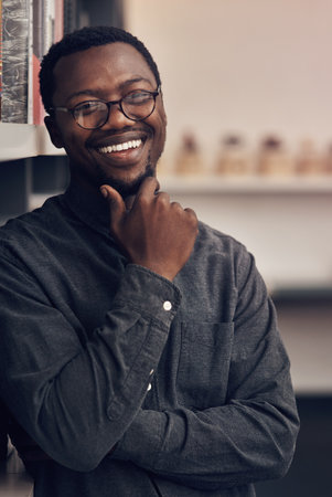I was determined to be a great designer then I became one. Cropped portrait of a handsome young male architect smiling while standing in a modern office.の写真素材