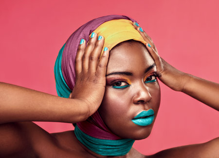 How do I look from this angle. Studio portrait of a beautiful young woman wearing a head wrap and...