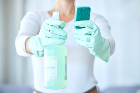 Woman, hands and detergent for housekeeping, cleaning or disinfect with latex gloves in sanitary...