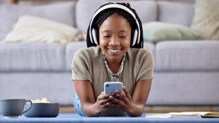 Black woman, student and phone with smile for elearning, education or entertainment by living room...