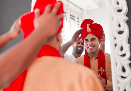 Today, you become a king. a young man helping his friend get dressed on his wedding day.の写真素材