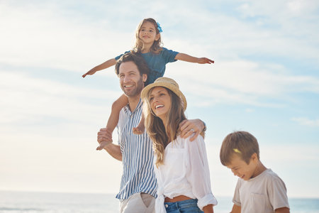 Were living for the moments we cannot put into words. a happy couple bonding with their two children during a day out on the beach together.の写真素材