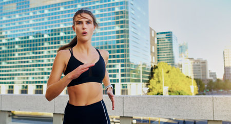 Calorie burning workouts demand cardio. a young woman going for a run in the city.の写真素材