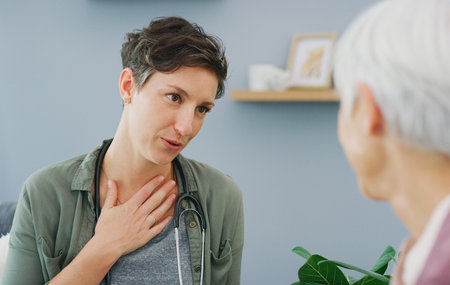This is my medical opinion. an attractive young healthcare professional sitting and talking to her senior patient while in the living room.の写真素材