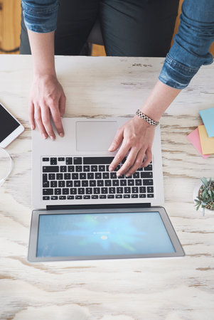 Get hands on and make it happen. Cropped high angle shot of a businesswoman using a laptop at her...