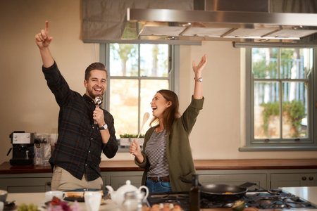 Theres no better way to start the day. an affectionate couple standing together in the kitchen at home.の写真素材