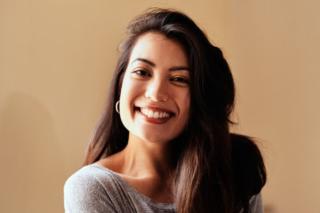 Happiness heals all. Portrait of a beautiful young woman posing against a brown background.