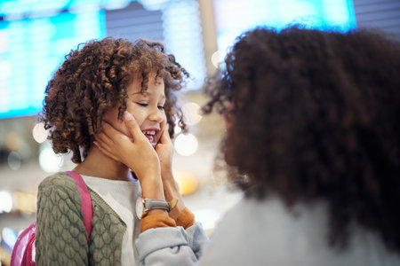 Reunion, travel and mother and girl at airport for vacation, global and welcome for flight. Smile, affectionate and hello with happy mom and child on holiday trip for bonding, relax or tourismの写真素材
