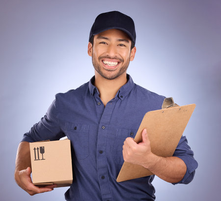 Delivery man, box and portrait isolated on studio background with courier services and clipboard and smile. Asian worker, supplier or logistics person package for Korea distribution and product salesの写真素材