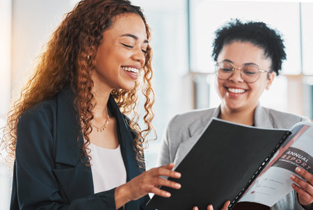 Businesswoman, document and team laughing for report planning, preparation or strategy at the office. Female manager smiling and laugh with colleague in analysis or fun project plan at the workplaceの写真素材