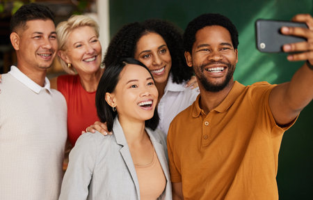 Selfie, smile and group of business people in office taking pictures for social media. Diversity teamwork, collaboration and happy friends, men and women laughing and take photo for profile picture.の写真素材