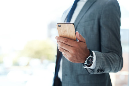 My service is a call away. an unrecognizable businessman using his cellphone.の写真素材