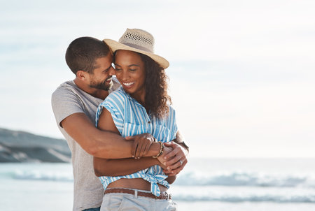 You know just how to make me happy. a young couple enjoying some quality time together at the beach.の写真素材