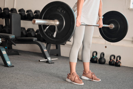 Fitness, weightlifting and woman in gym, barbell for bodybuilding and muscle training, strong with power and endurance. Exercise, health and female bodybuilder, workout equipment and active lifestyleの写真素材