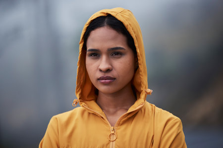 Serious, winter and woman in nature for fitness, running and thinking of motivation for training. Sports, idea and a female runner in the cold for exercise, cardio and looking at a path to trainの写真素材