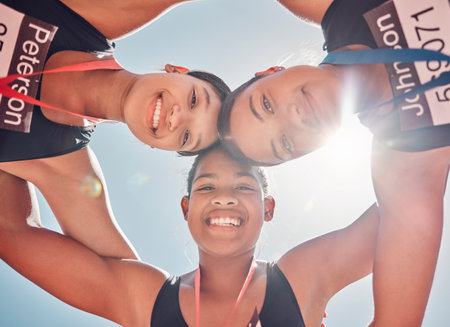 Portrait, women and runners in support huddle after fitness competition from below against blue sky mockup. Sports, friends and trust circle by athletes connect in wellness, training and motivationの写真素材
