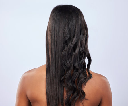 Back view, woman or hair care in studio for beauty self care or style treatment isolated on white background. Curly style, relaxing or girl model in salon spa in grooming routine on mockup spaceの写真素材