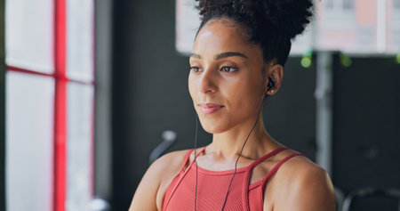 Black woman, breathe and earphones for music with fitness and exercise ready in gym, health and active motivation. Start, workout and calm for body training and endurance, wellness and listening.の写真素材
