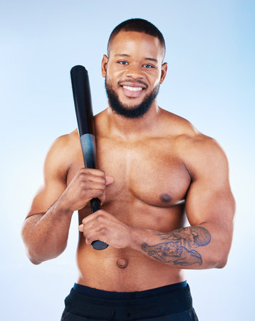 Baseball player, black man and studio portrait with smile, shirtless and happy for sports by blue background. Young fitness expert, body wellness and bat in hands for development, sport and workoutの写真素材