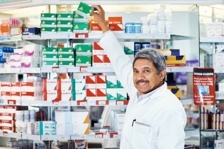 If its excellent service you seek, weve got it. Portrait of a mature pharmacist working in a chemist.の写真素材