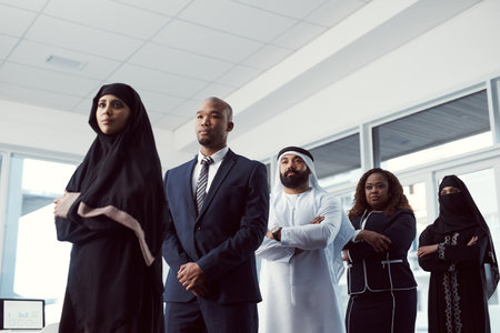 Dont wait for it, work for it. Low angle shot of a diverse group of business colleagues standing in a single line in their corporate office.の写真素材