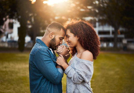 Lets make this love last. an affectionate young couple bonding together outdoors.の写真素材