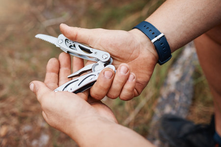 Hands, man or multi purpose knife in environment camping land, sustainability forest woods or hiking mountains. Zoom, hiker or swiss army blade, survival tools or metal equipment gear in nature earthの写真素材