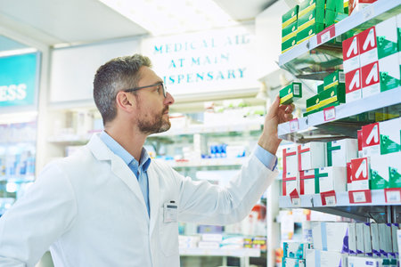 Pharmacists are the medication experts on the team of doctors. a mature pharmacist working in a pharmacy.の写真素材