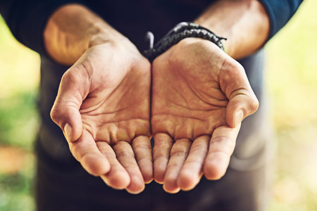 Can you help me please. Closeup shot of an unrecognizable man standing with his hands cupped together.の写真素材