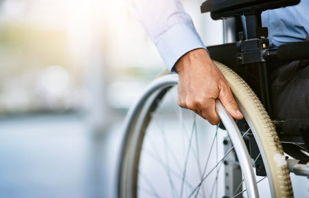 Wheeling his way into recovery. Closeup shot of an unrecognizable man sitting in a wheelchair.の写真素材