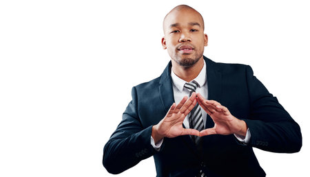 How he demonstrates the business triangle. Studio shot of a handsome young businessman making a triangle shape with his hands against a white background.の写真素材